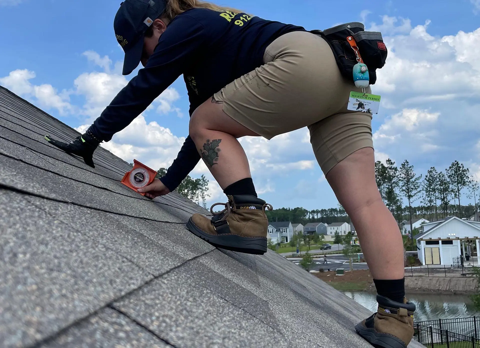 A woman working on the roof with equipment