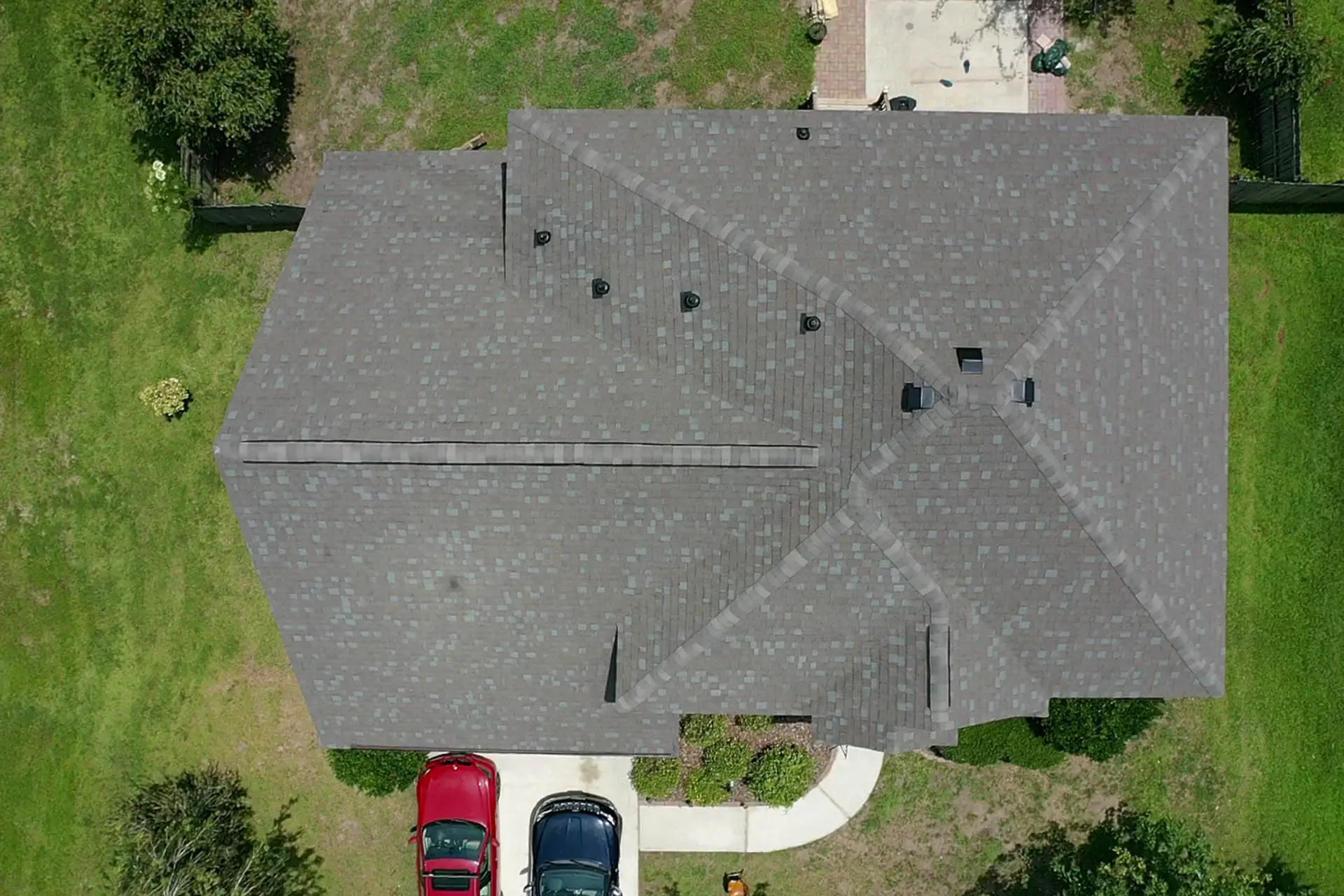An ariel view of a grey color roofing house