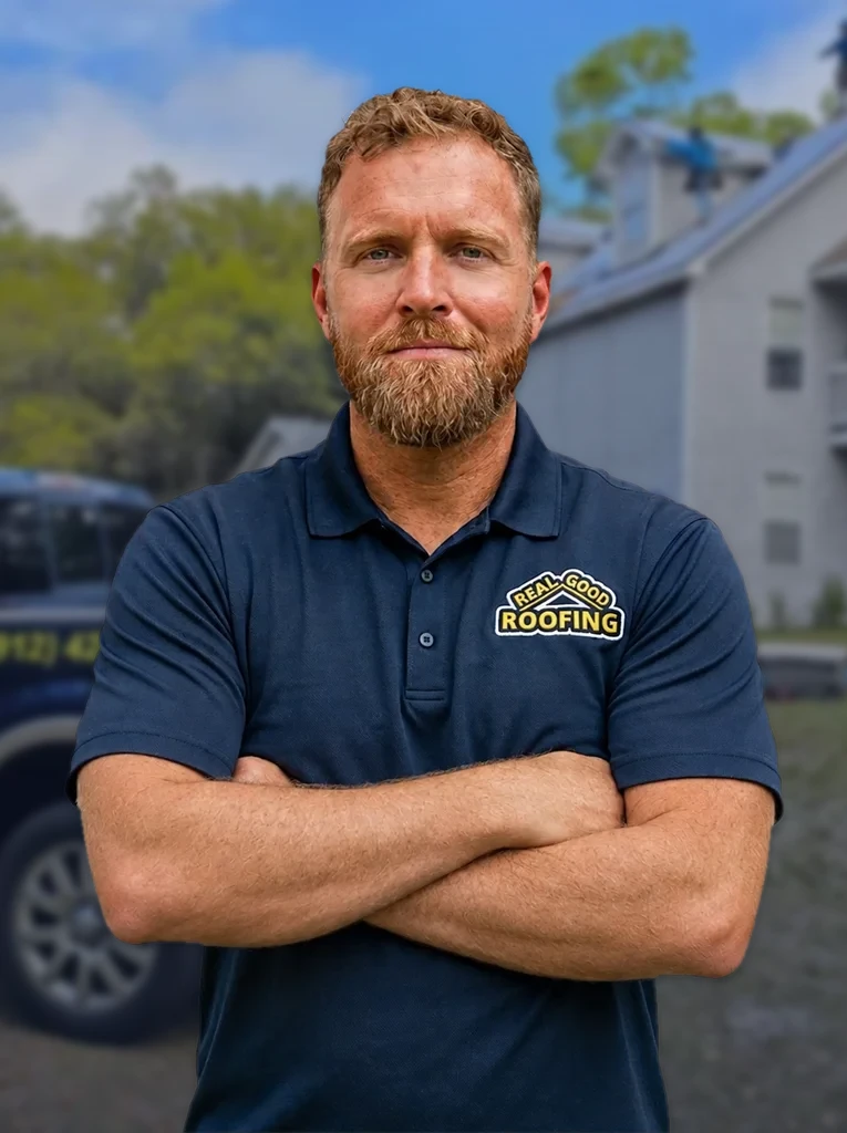 Justin Shoemaker, owner of Real Good Roofing, at a job site with the RGR truck